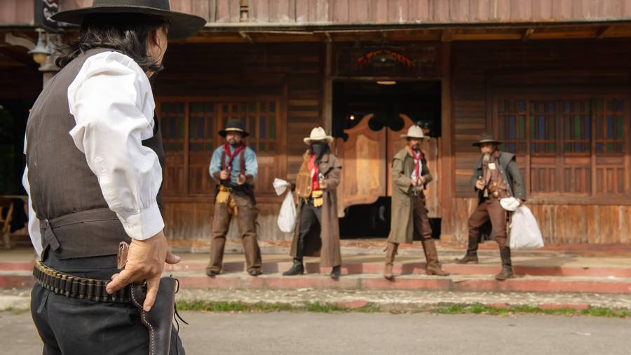 A western standoff scene outside a saloon